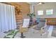 Cozy sunroom with wooden wall decor, comfortable chairs, and abundant natural light at 4196 E Highway 319, Conway, SC 29526
