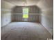 Unfinished bonus room featuring neutral walls and a window, ready to be designed as you wish at 4268 Long Avenue Ext., Conway, SC 29526