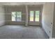 Unfinished living room with natural light coming in from the windows and patio door at 4268 Long Avenue Ext., Conway, SC 29526