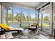 Bright sunroom with lake view, comfortable seating, and many windows at 4325 Deer Run Ave., Little River, SC 29566