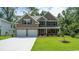 Beautiful two-story home featuring stone accents, neutral siding, a two-car garage, and a well-manicured lawn at 443 Clear Lake Dr., Conway, SC 29526