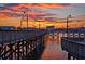 Boardwalk at sunset with streetlights and buildings silhouetted against a colorful sky at 4712 Cobblestone Dr. # K-7, Myrtle Beach, SC 29577