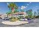 Condominium exterior showcasing maintained landscaping and a palm tree in the front with plenty of parking spaces at 4712 Cobblestone Dr. # K-7, Myrtle Beach, SC 29577