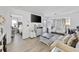 Bright living room with hardwood floors, a large TV, neutral decor, and an adjacent bedroom at 4712 Cobblestone Dr. # K-7, Myrtle Beach, SC 29577