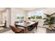 Bright dining area with large windows, stylish wicker chairs, and views of the backyard at 477 Blissful Ln., Little River, SC 29566