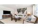 Bright living room featuring a plush sofa, contemporary decor, and a large entertainment center at 477 Blissful Ln., Little River, SC 29566