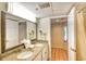 Bright bathroom featuring double sinks and a door leading to the shower area at 4800 S Ocean Blvd. # 708, North Myrtle Beach, SC 29582