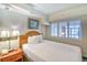 Comfortable bedroom featuring a queen bed, nightstand, and soft lighting at 4800 S Ocean Blvd. # 708, North Myrtle Beach, SC 29582
