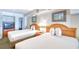 Inviting bedroom with two queen beds, closet, and TV for relaxing stays at 4800 S Ocean Blvd. # 708, North Myrtle Beach, SC 29582