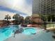 Resort pool with mushroom water feature, lounge chairs, and palms at 4800 S Ocean Blvd. # 708, North Myrtle Beach, SC 29582
