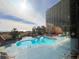 Bright pool with beach access, chairs, and building in the background at 4800 S Ocean Blvd. # 708, North Myrtle Beach, SC 29582