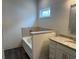 Bathroom showcases a granite-topped vanity, bathtub and a window offering natural light at 484 Honeyhill Loop, Conway, SC 29526