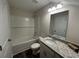 Bright bathroom with a granite-topped vanity, framed mirror, and shower-tub combo at 484 Honeyhill Loop, Conway, SC 29526