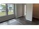 Bright bedroom with hardwood flooring and view of the yard through large windows at 484 Honeyhill Loop, Conway, SC 29526