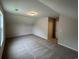 An upstairs bonus room with carpet, and neutral colored walls and ceiling at 484 Honeyhill Loop, Conway, SC 29526