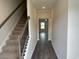 Inviting entryway featuring a staircase and hardwood flooring that leads to a bright living area at 484 Honeyhill Loop, Conway, SC 29526
