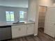 Kitchen with white cabinetry, granite countertops, hardwood floors, and stainless steel dishwasher at 484 Honeyhill Loop, Conway, SC 29526