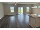 Open-concept living room with hardwood floors, multiple windows, and ceiling fan fixture at 484 Honeyhill Loop, Conway, SC 29526
