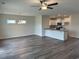 Bright living room area featuring hardwood flooring, lots of natural light, and modern lighting fixture at 484 Honeyhill Loop, Conway, SC 29526
