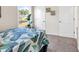 Well-lit bedroom featuring neutral walls, plush carpeting, and a view of the outdoors at 500 Honeyhill Loop, Conway, SC 29526