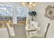 Intimate dining area with views of the surrounding pond, bright light, and comfortable seating at 500 Honeyhill Loop, Conway, SC 29526