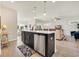 The kitchen features a kitchen island with a dishwasher and sink and opens into the living area beyond at 500 Honeyhill Loop, Conway, SC 29526
