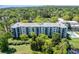 Aerial view of a condo building surrounded by lush greenery, offering serene views of the water and city skyline at 5001 Little River Rd. # 501E, Myrtle Beach, SC 29577