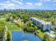 Aerial view of condo complex, golf course, pond, swimming pool, and partial ocean view at 5001 Little River Rd. # 501E, Myrtle Beach, SC 29577