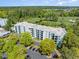 Stunning aerial view of a condo building overlooking lush golf course and parking, surrounded by beautiful trees and landscaping at 5001 Little River Rd. # 501E, Myrtle Beach, SC 29577