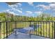 Balcony overlooking a picturesque lake and a lush green golf course under a partly cloudy sky at 5001 Little River Rd. # 501E, Myrtle Beach, SC 29577