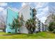 Exterior view of a multi-story building showcasing balconies and well-manicured landscaping at 5001 Little River Rd. # 501E, Myrtle Beach, SC 29577