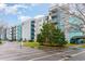 View of the condo building with blue and grey paint, landscaping, and balconies at 5001 Little River Rd. # 501E, Myrtle Beach, SC 29577