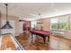 Game room with a pool table, shuffleboard, and windows with natural light for entertainment at 5001 Little River Rd. # 501E, Myrtle Beach, SC 29577