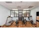 Well-equipped gym featuring a treadmill, rowing machine, and other exercise equipment on a modern hardwood floor at 5001 Little River Rd. # 501E, Myrtle Beach, SC 29577