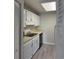 Galley kitchen with white cabinets, laminate countertops, and black appliances at 5001 Little River Rd. # 501E, Myrtle Beach, SC 29577