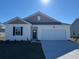 Charming single-Gathering home featuring a one car garage and well manicured lawn at 504 Blissful Ln., Little River, SC 29566