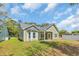The home's backyard shows the patio, well-manicured lawn, and the home's exterior at 5132 Little River Neck Rd., North Myrtle Beach, SC 29582
