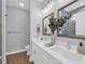 Bathroom features dual sinks, white cabinets, and decorative accents at 5132 Little River Neck Rd., North Myrtle Beach, SC 29582