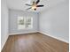 Bright, neutral bedroom featuring a ceiling fan and a large window at 5132 Little River Neck Rd., North Myrtle Beach, SC 29582