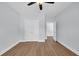 Neutral bedroom featuring wood-look floors, ceiling fan and large closet at 5132 Little River Neck Rd., North Myrtle Beach, SC 29582
