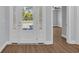 Close up of front door opening into entryway with consistent flooring throughout home at 5132 Little River Neck Rd., North Myrtle Beach, SC 29582