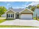 Charming single-story home with a welcoming front entrance and a two-car garage at 5132 Little River Neck Rd., North Myrtle Beach, SC 29582
