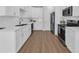 Contemporary kitchen featuring white cabinets, stainless steel appliances, and subway tile backsplash at 5132 Little River Neck Rd., North Myrtle Beach, SC 29582