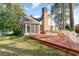 Back of house featuring screened-in porch, deck, mature trees and partial pond view at 2934 Midiron Ct., Myrtle Beach, SC 29577