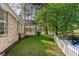 Beautiful backyard featuring a screened-in porch, lush greenery, and mature trees by the pond at 2934 Midiron Ct., Myrtle Beach, SC 29577