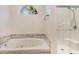Relaxing bathroom featuring a soaking tub and separate shower with a unique window feature at 2934 Midiron Ct., Myrtle Beach, SC 29577