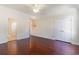 This bedroom boasts hardwood floors, a ceiling fan, and an attached closet and doorway at 2934 Midiron Ct., Myrtle Beach, SC 29577