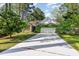 Charming single-story home with a well-maintained lawn and attached two-car garage with verdant foliage at 2934 Midiron Ct., Myrtle Beach, SC 29577