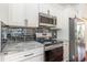 Modern kitchen with stainless steel appliances, black subway tile backsplash and marble countertops at 2934 Midiron Ct., Myrtle Beach, SC 29577
