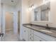 Bathroom featuring double sink vanity with granite countertops and a tiled shower at 549 Honeyhill Loop, Conway, SC 29526